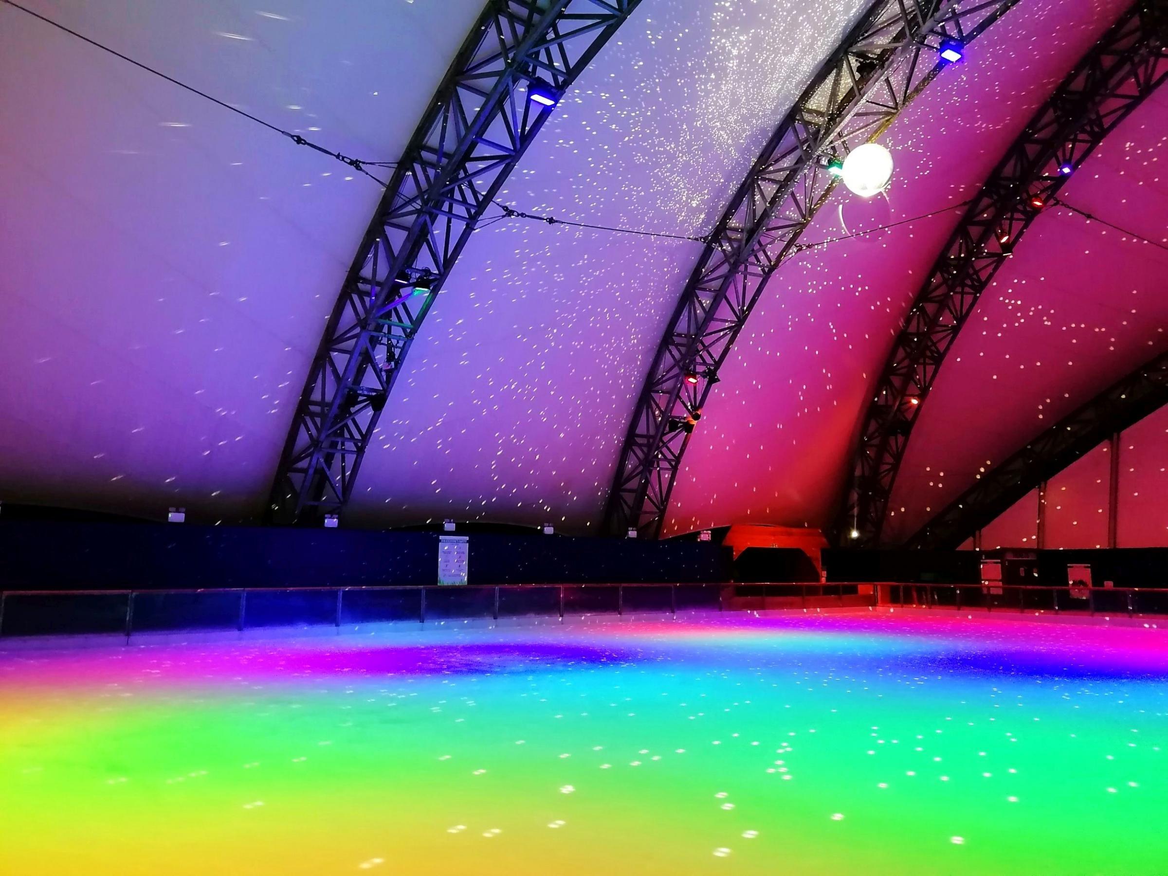 The skating rink is lit with ever-changing colours