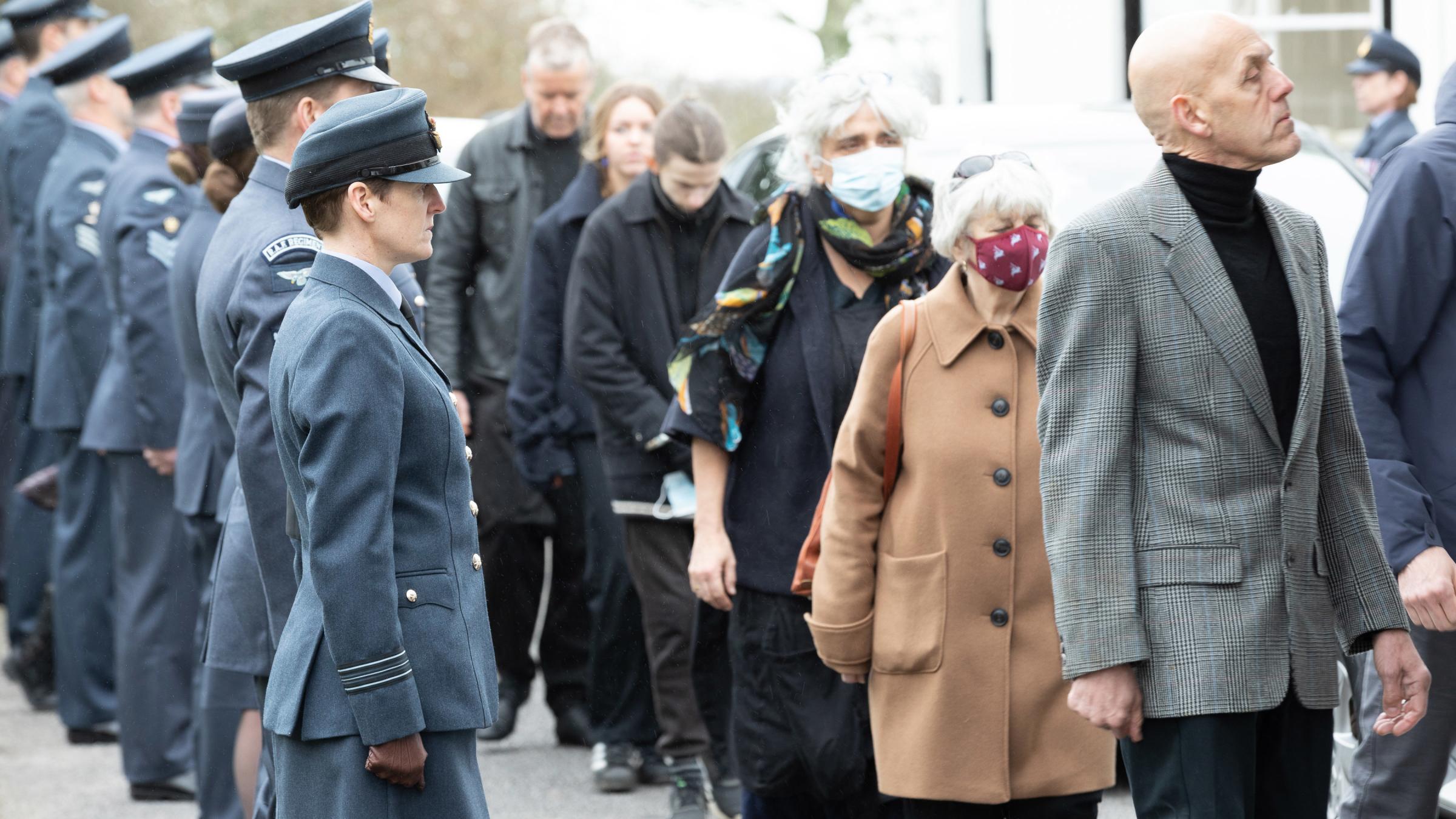 Station Personnel from RAF St Mawgan line the road leading upto Penmount Crematorium as family and friends of Dr James enter Penmount Crematorium.