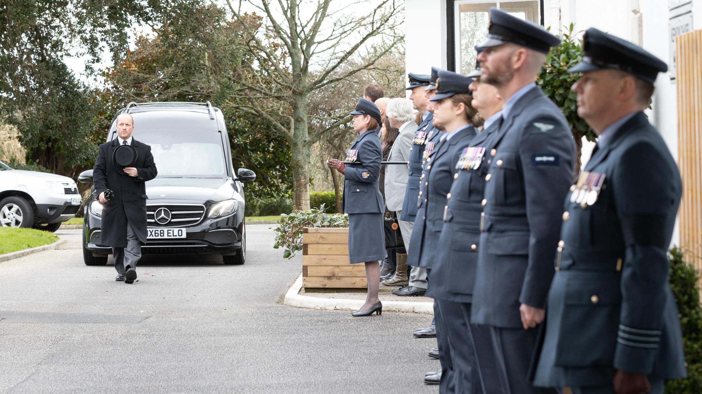 Personnel from RAF St Mawgan line the entrance to Penmount Crematorium as Dr James arrives.