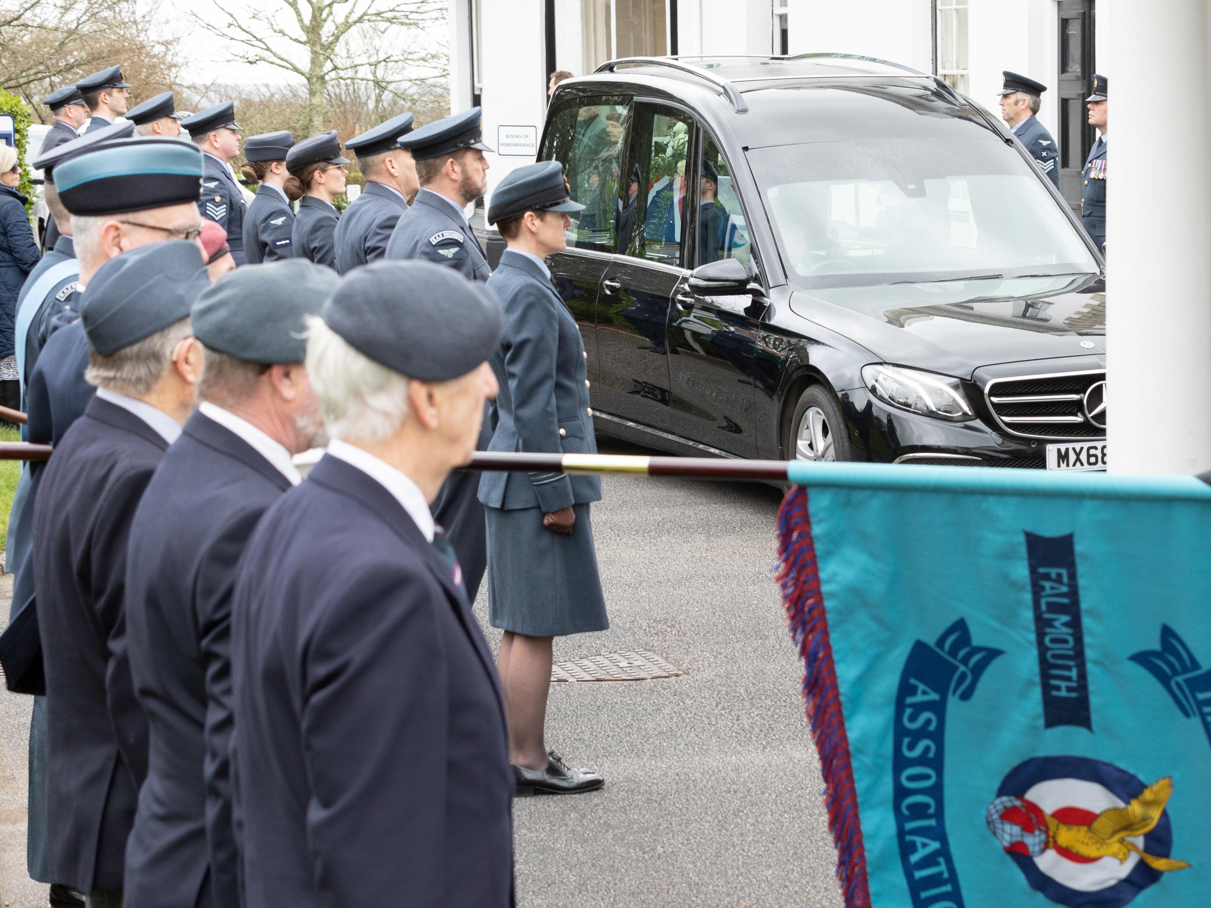 Station personnel from RAF St Mawgan Stand to attention along with RAF Veterans as Dr James arrives at Penmount Crematorium.