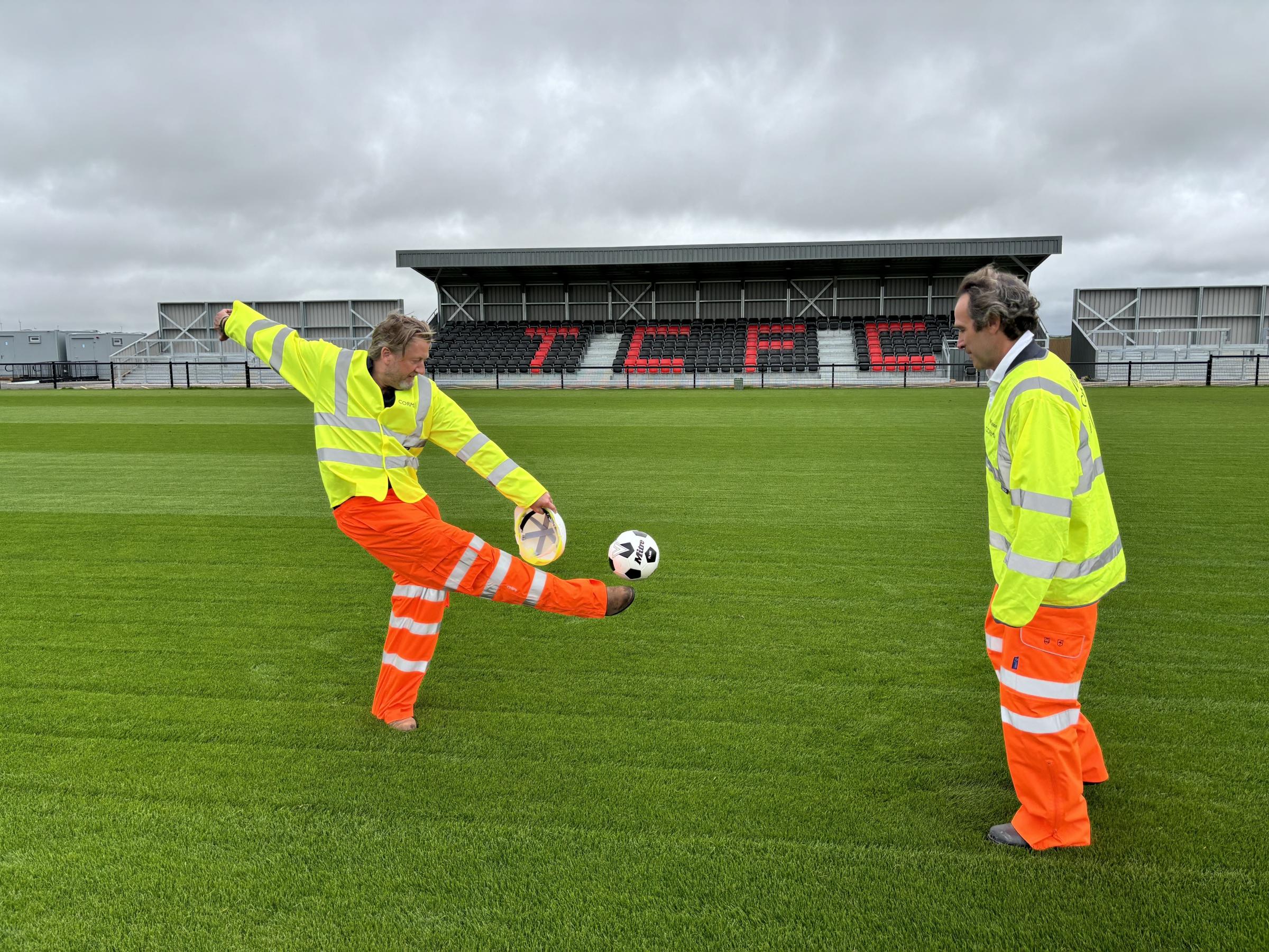 Treveth\s Harry Lewis, left, and Cornwall councillor Olly Monk have a kickabout on the new pitch (Pic: Lee Trewhela / LDRS)